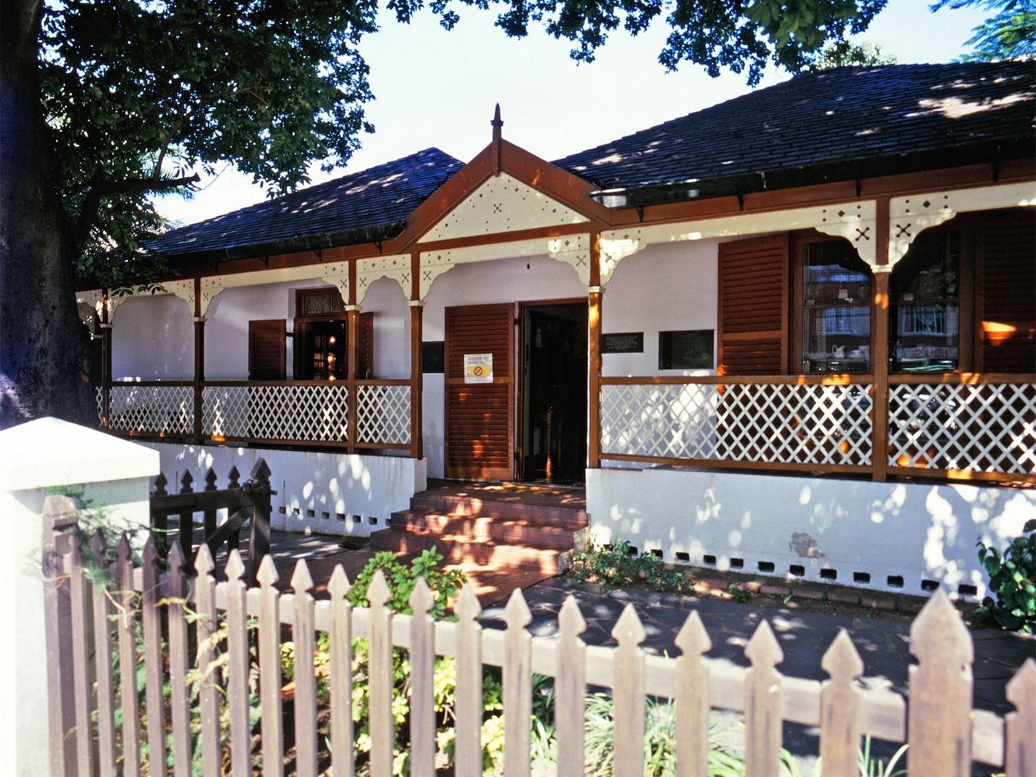The Old House Museum, a single-storey Victorian house with a veranda and picket fence